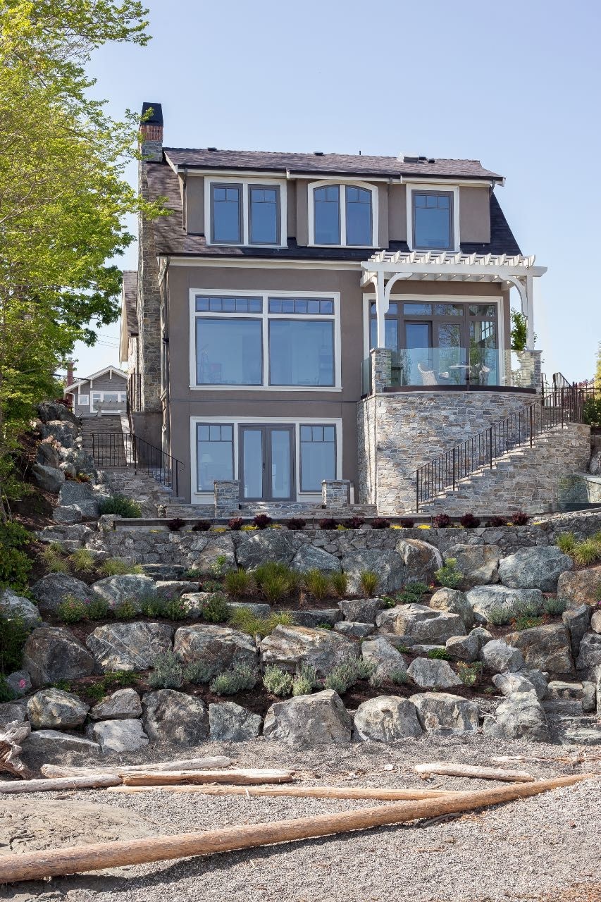 back exterior of King George Terrace home with beach garden