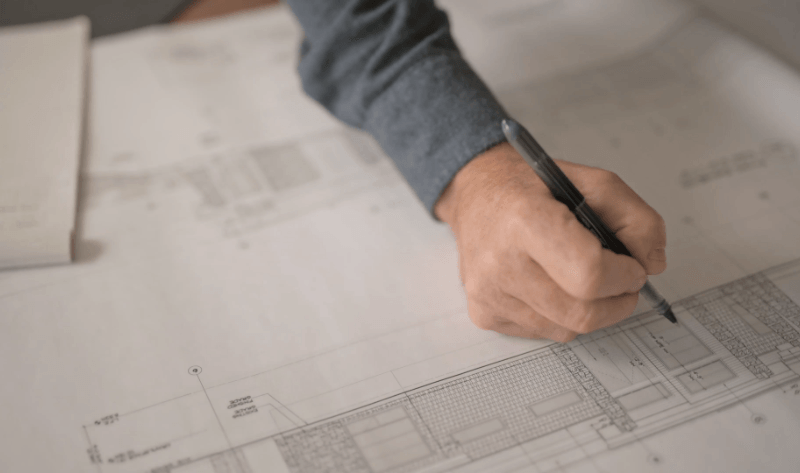 Chris Walker reviewing construction drawings at his desk