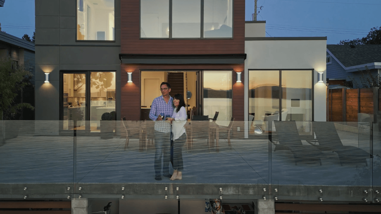 clients of Christopher Developments enjoying their new custom home's deck and view