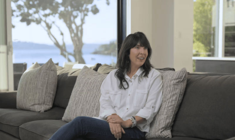 Madrona client sitting on couch giving testimonial for Christopher Developments